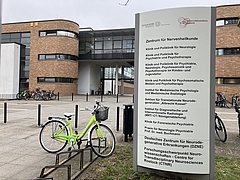 Ansicht eines Eingangs zu einem Gebäudekomplex, im Vordergrund sind Fahrradstellplätze zu sehen