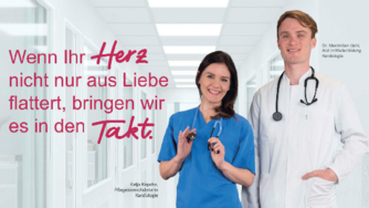 2 Personen in Arztkleidung stehen nebeneinander und lächeln