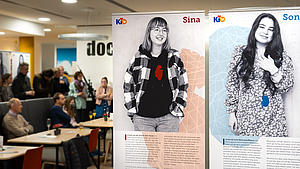 Im Vordergrund stehen große Plakate mit Menschen drauf