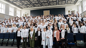 Staattssekretärin und das CCC-MV-Team stehen im Hörsaal in Reihe vor den Schülern.