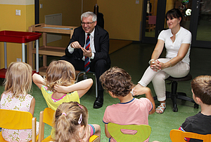 Prof. Dr. Steffen Emmert vermittelt den Kindern der Kita Gewächshaus wie Sonnenschutz richtig geht.